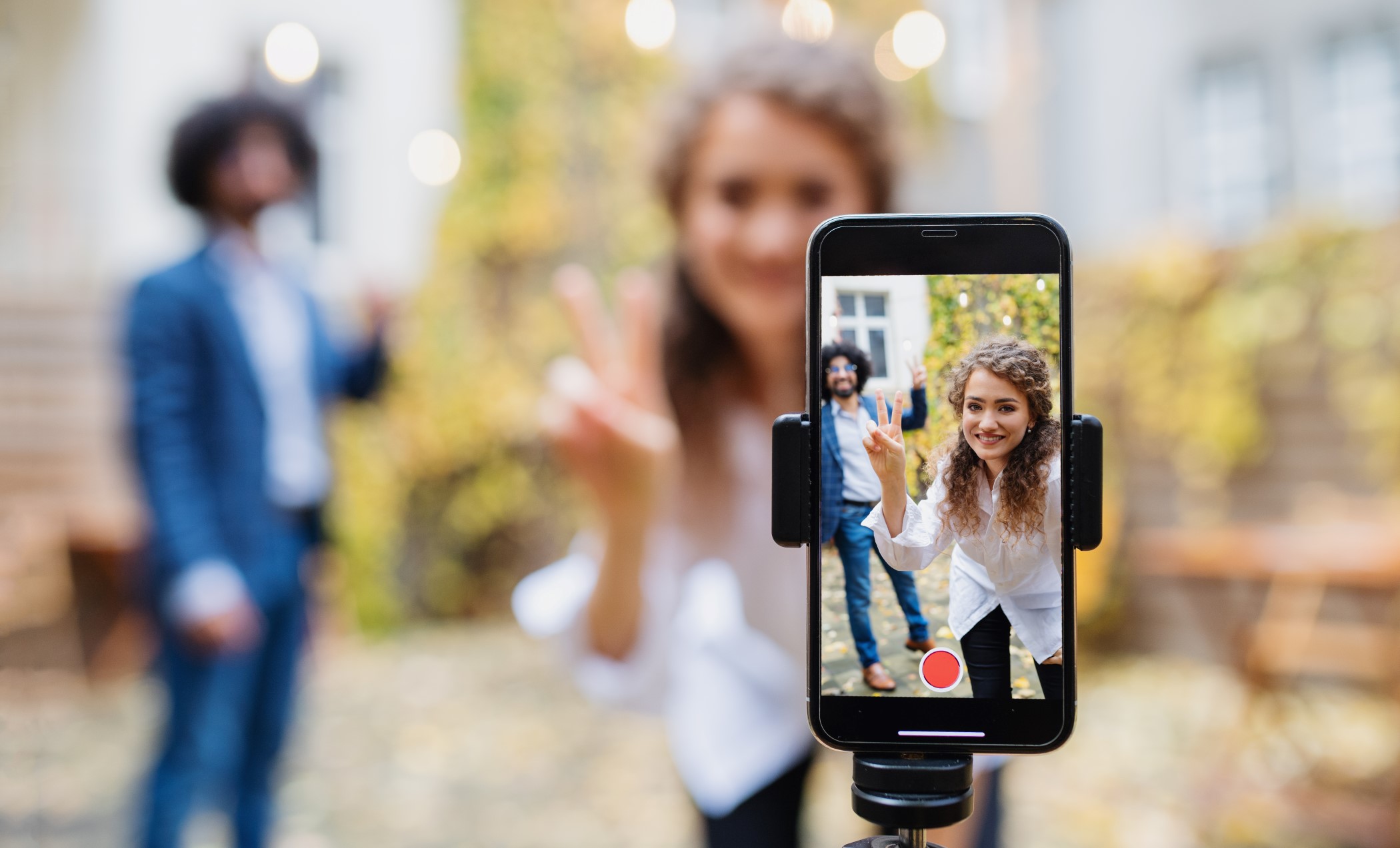 Young couple making video with smartphone for tik tok or instagram marketing in greenville sc